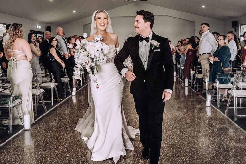 Bride and groom exiting their ceremony at the Chapel at Willow and Ivie wedding venue Mildura, photographed by Miss Moody Photography