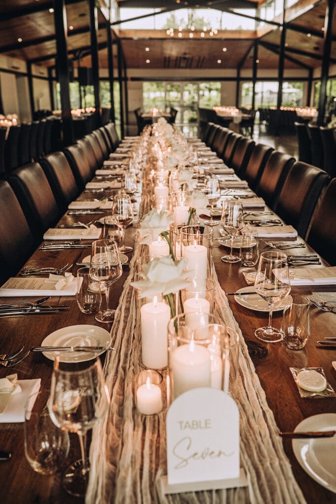 Willow and Ivie Venue Reseption setup with candles and table signs 