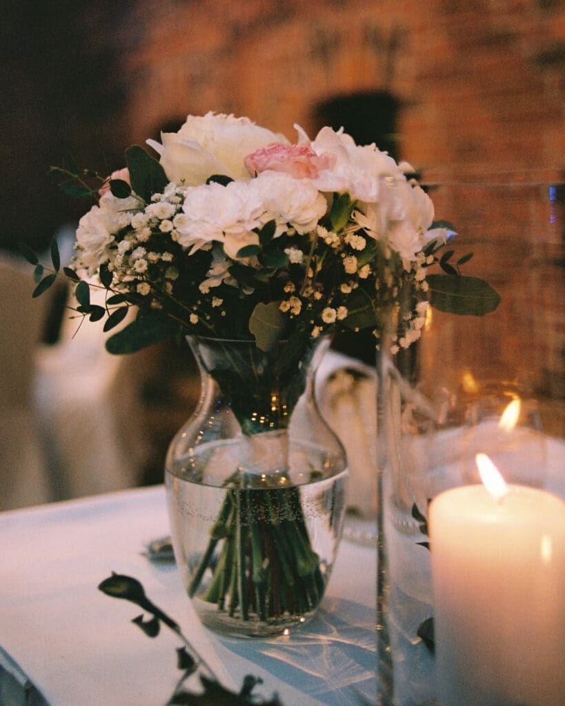 Wedding reception table detail with candle and flower bouquet Ravintola Sipuli Helsinki, film photography, Miss Moody Photography — Häävastaanoton pöytäyksityiskohta kynttilällä ja kukkasidonnainen Ravintola Sipulissa Helsingissä, filmivalokuvaus, Miss Moody Photography