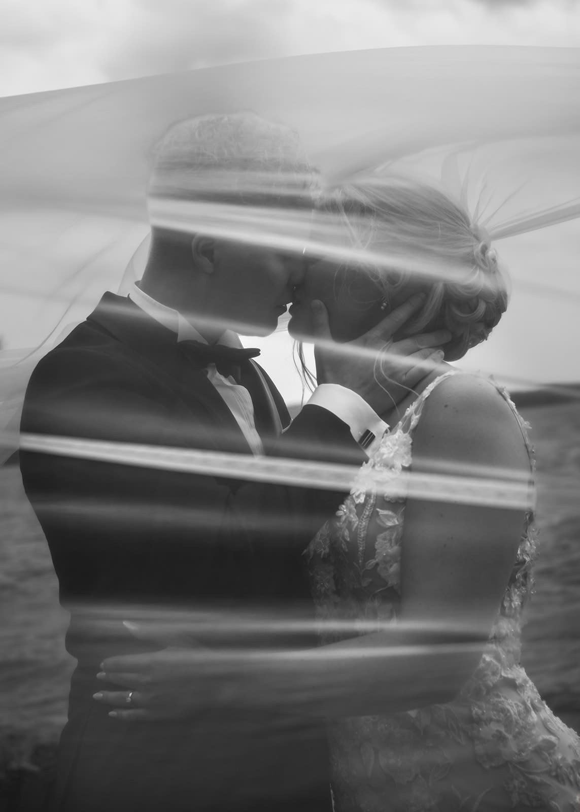 Black and white wedding portrait of bride and groom kissing under a pearl veil at Aurantola manor wedding in Jaala Kymenlaakso Finland, moody documentary wedding photography by Miss Moody Photography, Finnish Australian wedding photographer available in Finland every summer